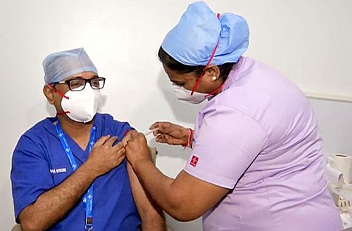A healthcare worker is administered the Covid vaccine
