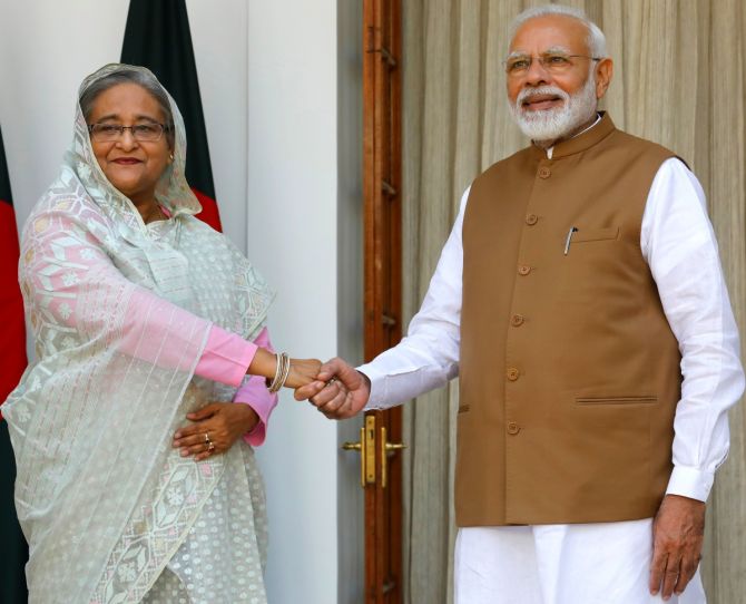 India's Prime Minister Narendra Modi shakes hands with his Bangladeshi counterpart Sheikh Hasina before their meeting at Hyderabad