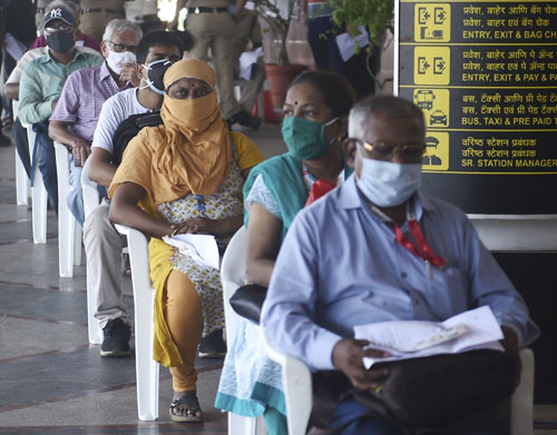 People wait to get vaccinated in Mumbai