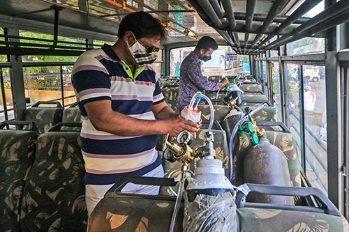 Oxygen cylinders being installed in a Jeevan Rath bus in Jaipur