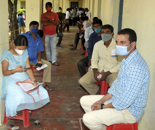 People wait to get vaccinated