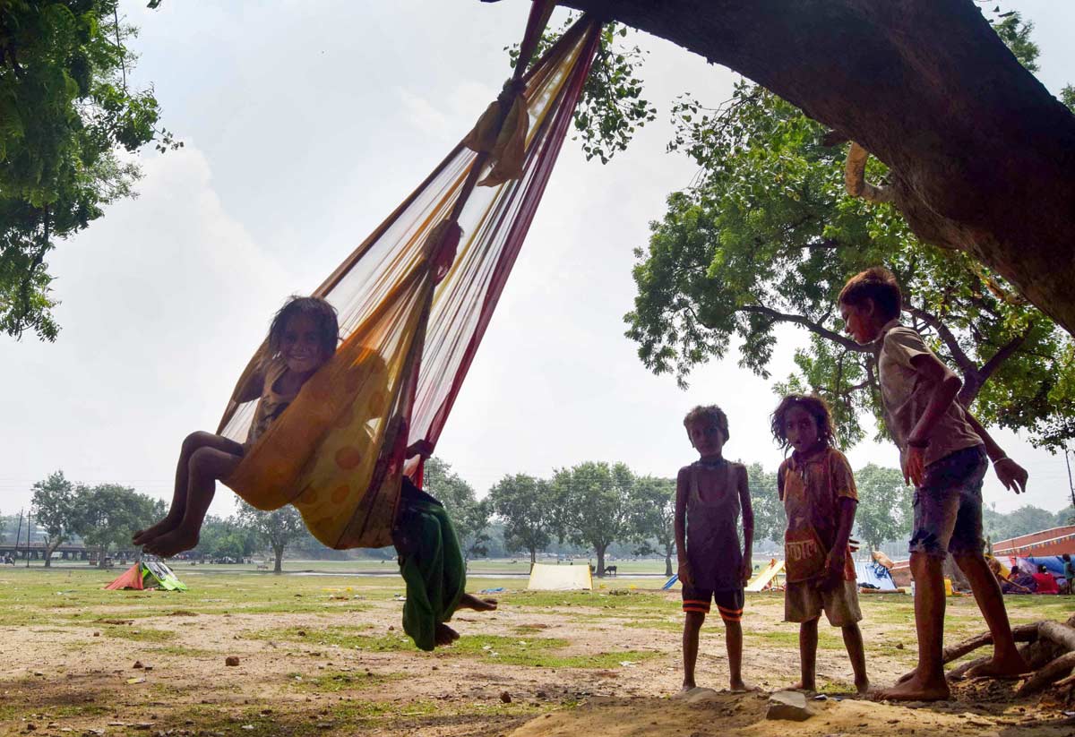 Children playing on a makeshift swing. Representational image