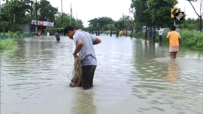 Locals take to fishing on a waterlogged highway of deluge-hit Assam