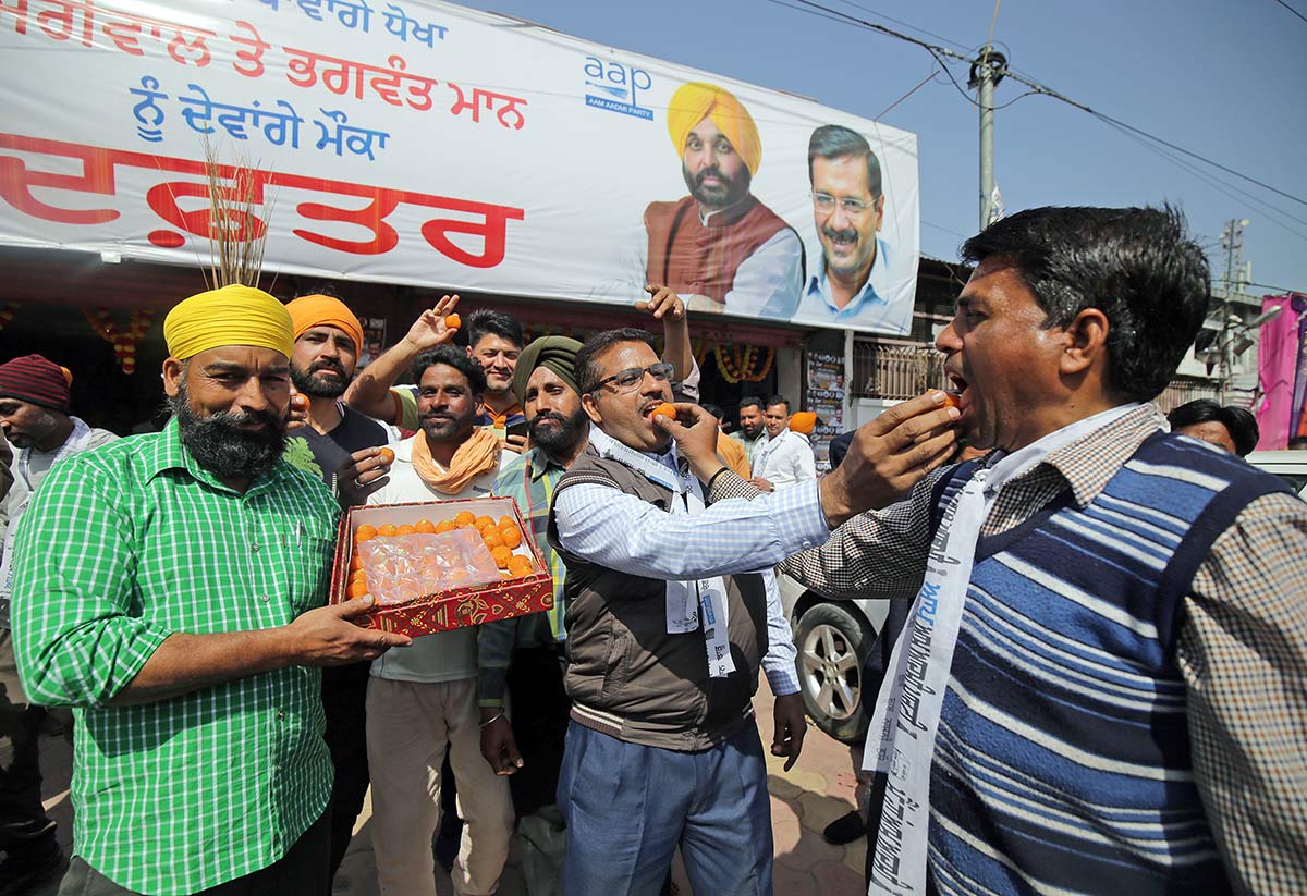 AAP workers distribute sweets in Amritsar