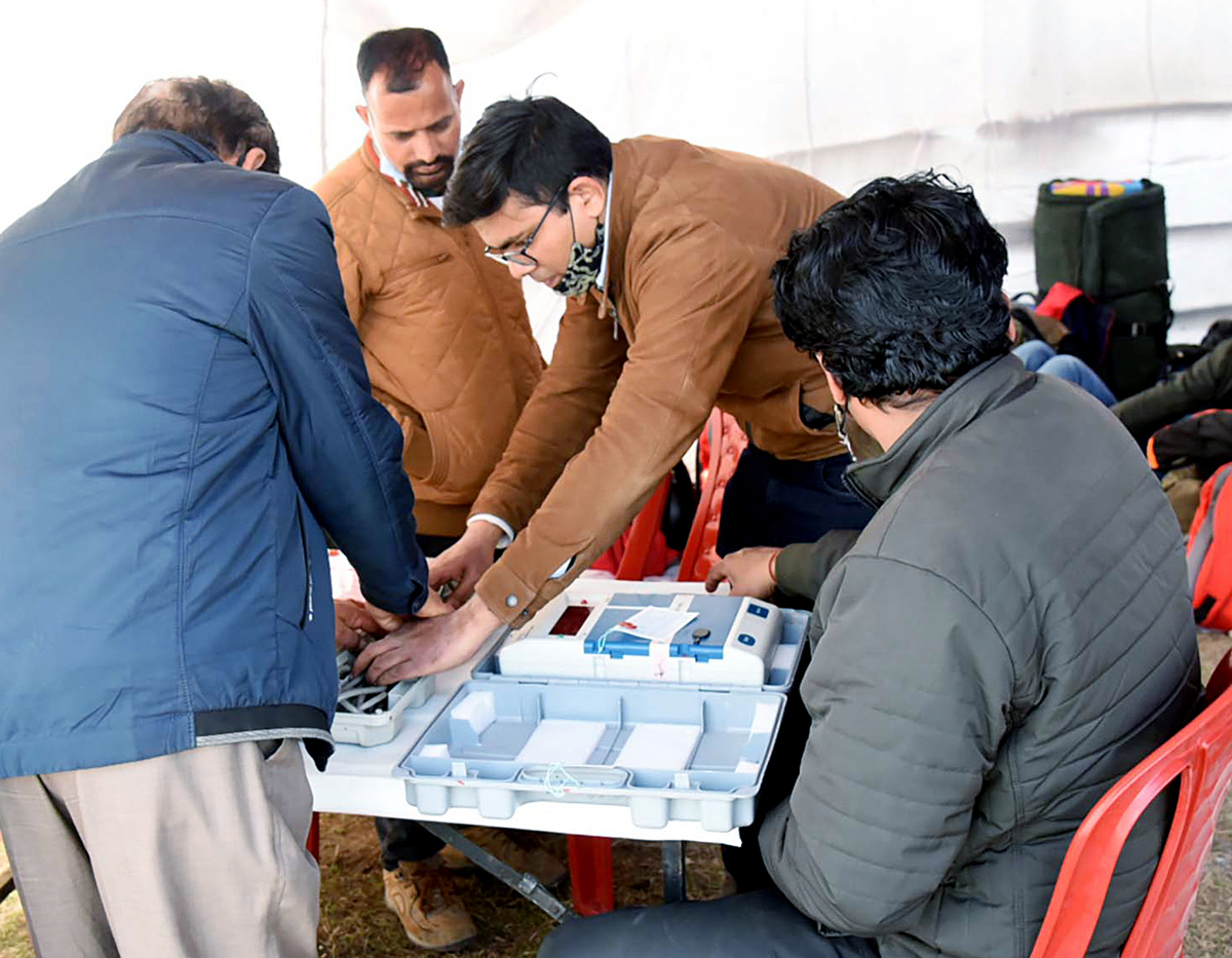 A polling officer checks an EVM in Uttarakhand