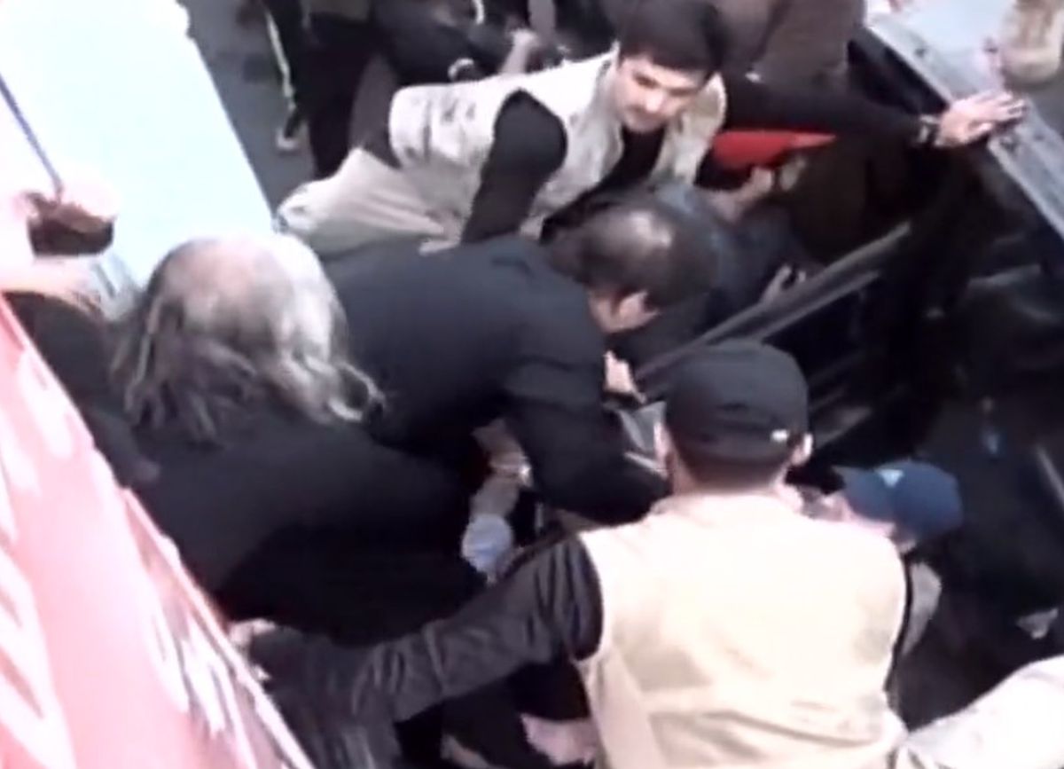Imran Khan being shifted to a car after firing