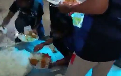 Video grab of the players being served food in a toilet
