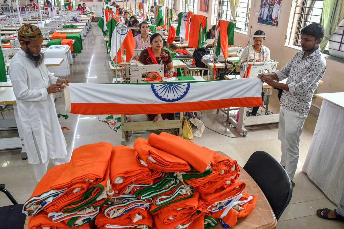 Jharkhand Rajya Khadi Gram workers stitching tri-color National flag