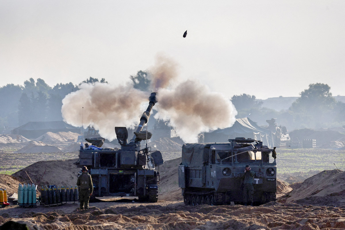 Israeli soldiers fire into Gaza. Amir Cohen/Reuters