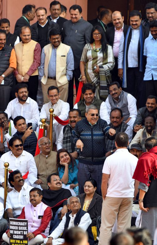 Kalyan Banerjee (standing in dark glasses) reacts to Rahul Gandhi (white T-shirt)
