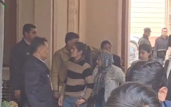 Neelam Devi (in head scarf) brought to court