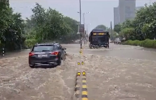 Vehicles passing through a flooding road in Gurugram amid heavy rain/ANI
