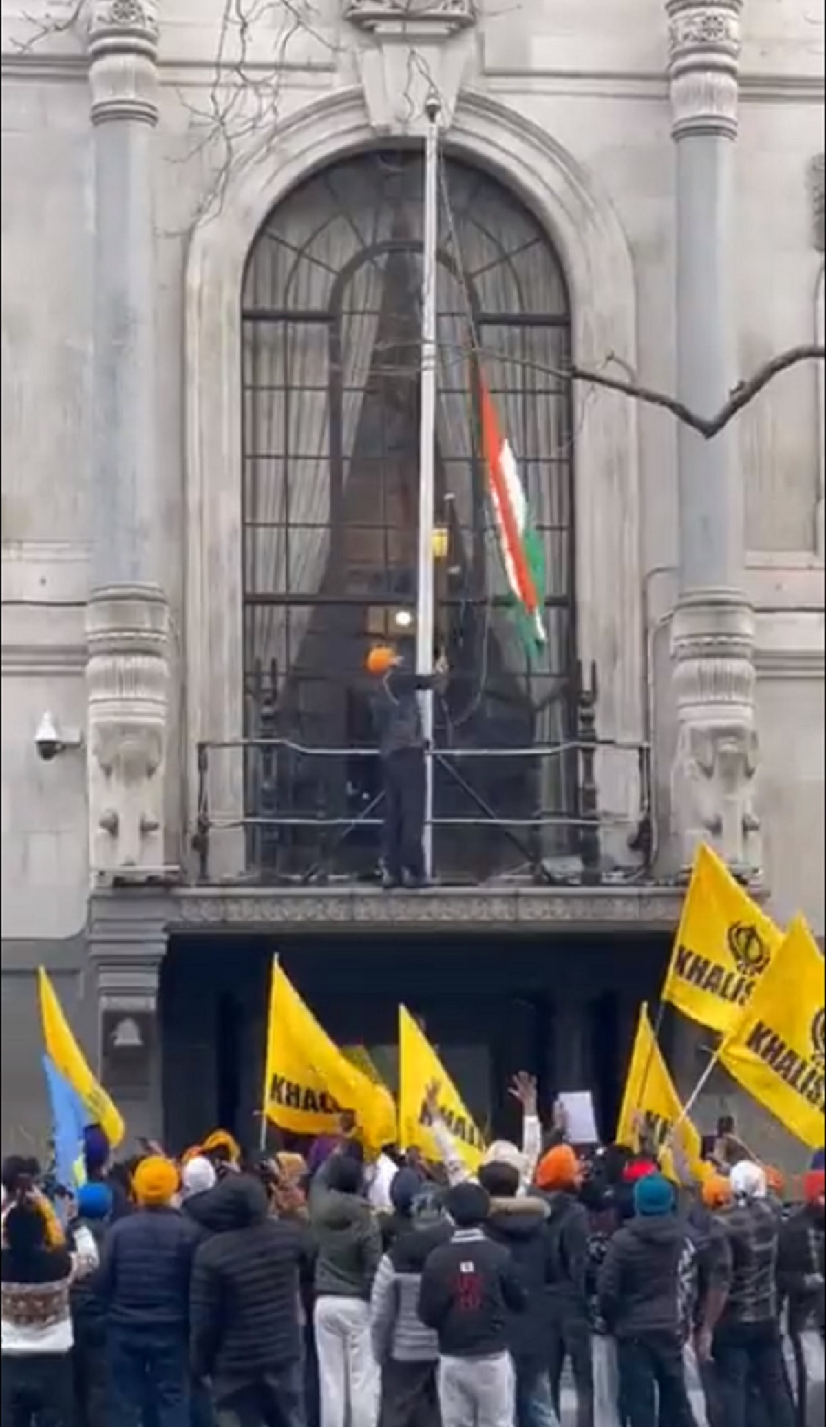 A screen grab taken from video of Khalistani supporters attempt to pull down tricolour at the high commission of India, in UK