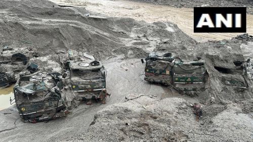 Army trucks covered in the silt of the Teesta river