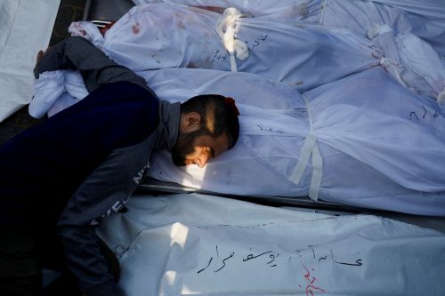 A Palestinian man grieves over deaths. Mohammed Salem/Reuters