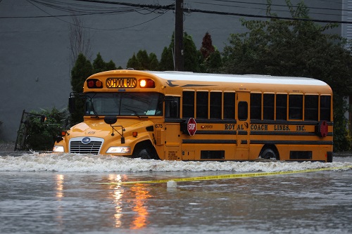 A school bus drives through heavy flooding in the New York City suburb of Larchmont, New York/Mike Segar/Reuters