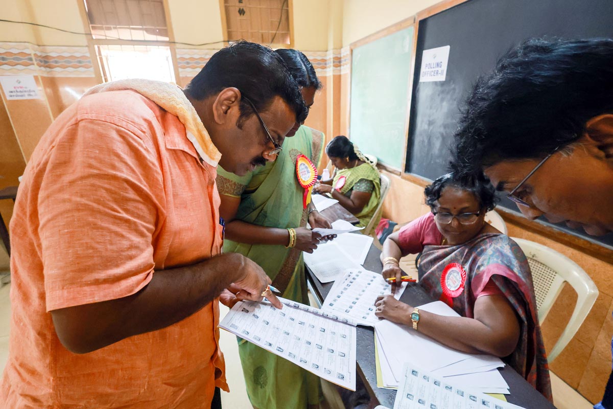 Polling officials check names of voters in the voter list at a polling station in Chennai/ANI Photo
