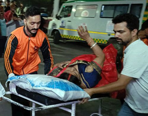An injured pilgrim being taken to hospital in Reasi