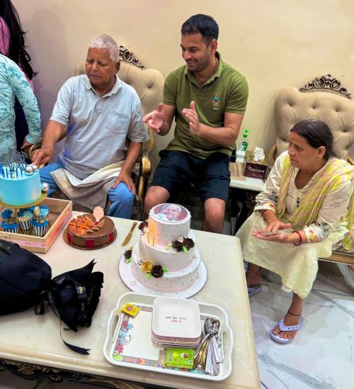 Lalu cuts his cake and eats it too. Seen here with Rabri Devi and Tej Pratap