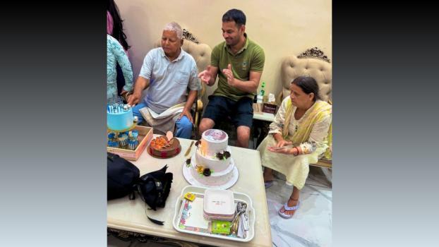 Lalu cuts his cake and eats it too. Seen here with Rabri Devi and Tej Pratap