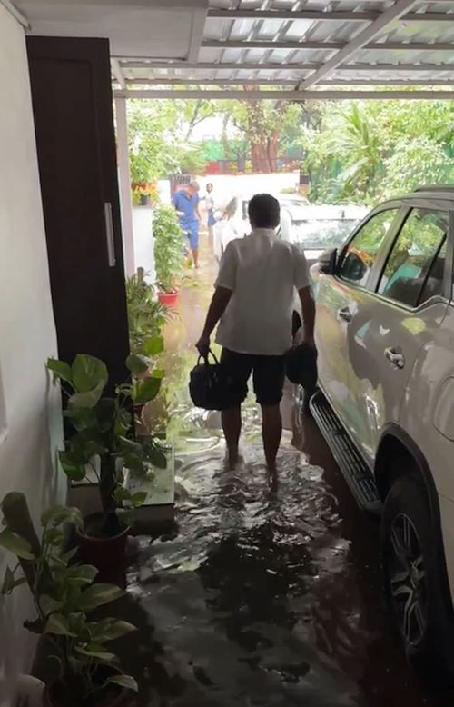 Cong MP Manish Tewari wades through the water at his home