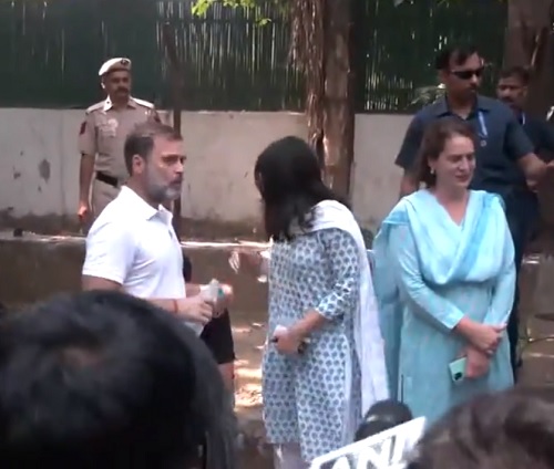 Congress MP Rahul Gandhi and Priyanka Gandhi Vadra wait outside a polling booth in New Delhi/ANI on X