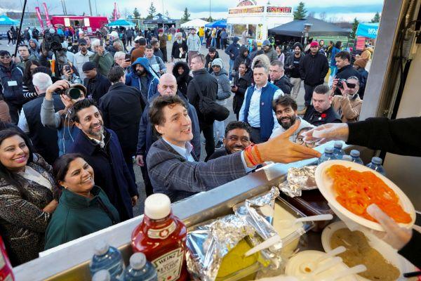 The Canada PM buys jalebi at Brampton during Diwali. Arlyn McAdorey/Reuters