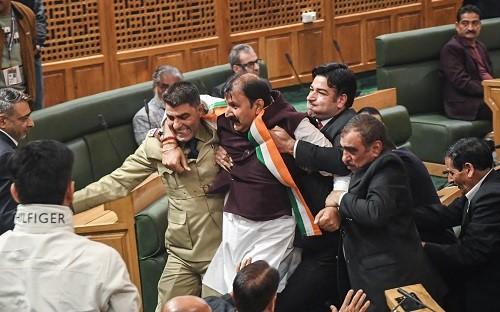 BJP MLAs being marshalled out of the Jammu & Kashmir assembly on Friday/ANI Photo