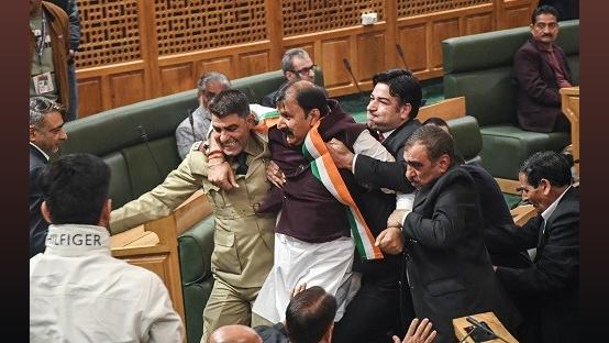 BJP MLAs being marshalled out of the Jammu & Kashmir assembly on Friday/ANI Photo