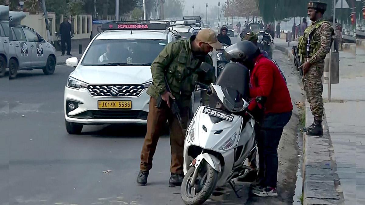 Security personnel check vehicles in the Zabarwan forest area