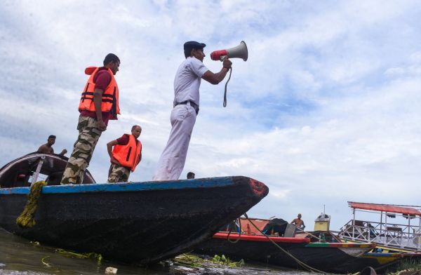 A river traffic patrol in Kolkata warns fishermen