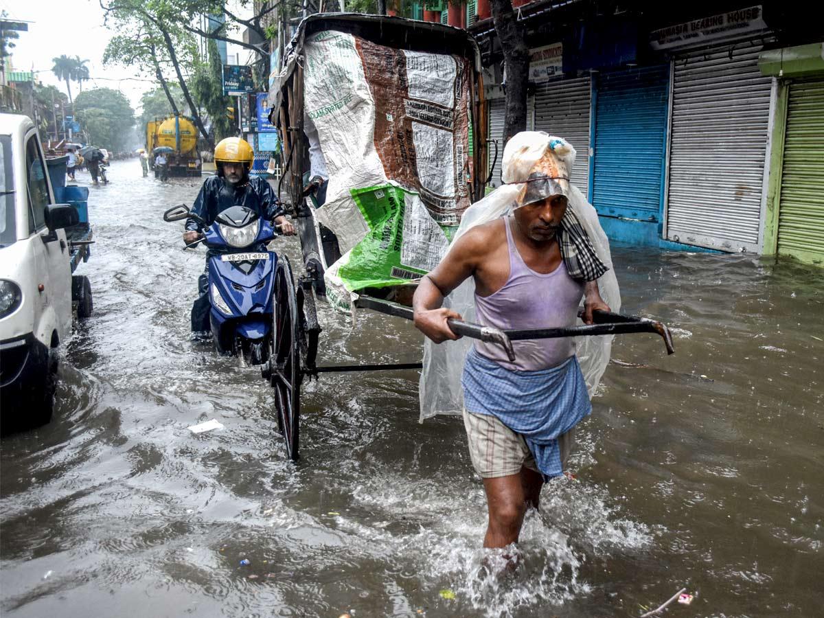 A rickshaw puller wades through a waterlogged road following heavy rainfall as an effect of the 'Dana' cyclone, in Kolkata on Friday./ANI Photo