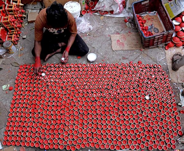 A man in Delhi keeps diyas ready ahead of Diwali