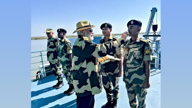 PM Narendra Modi offers sweets to a BSF jawan, in the Sir Creek area, Katch/ANI Photo
