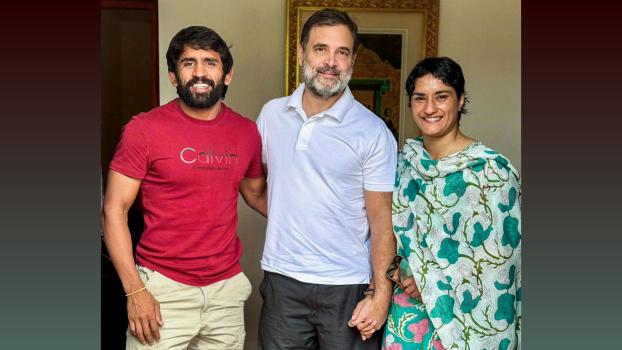 Vinesh Phogat (R) and Bajrang Punia meet with LoP in LS Rahul Gandhi, in New Delhi/ANI Photo