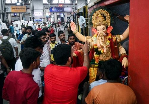 Devotees transport Lord Ganesh's idol in a train ahead of the Ganesh Chaturthi festival, at Mumbai Central Railway Station/ANI Photo