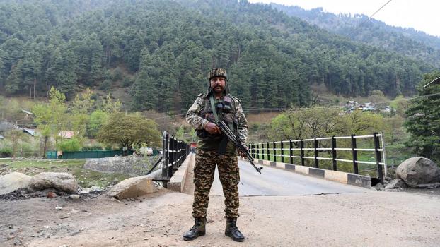 A security personnel stands guard at Pahalgam
