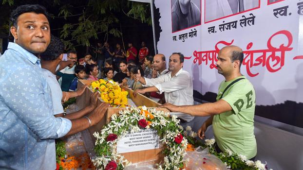 People pay their respects to the victims in Mumbai