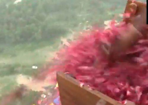 Flower petals being showered on devotees from a chopper in UP