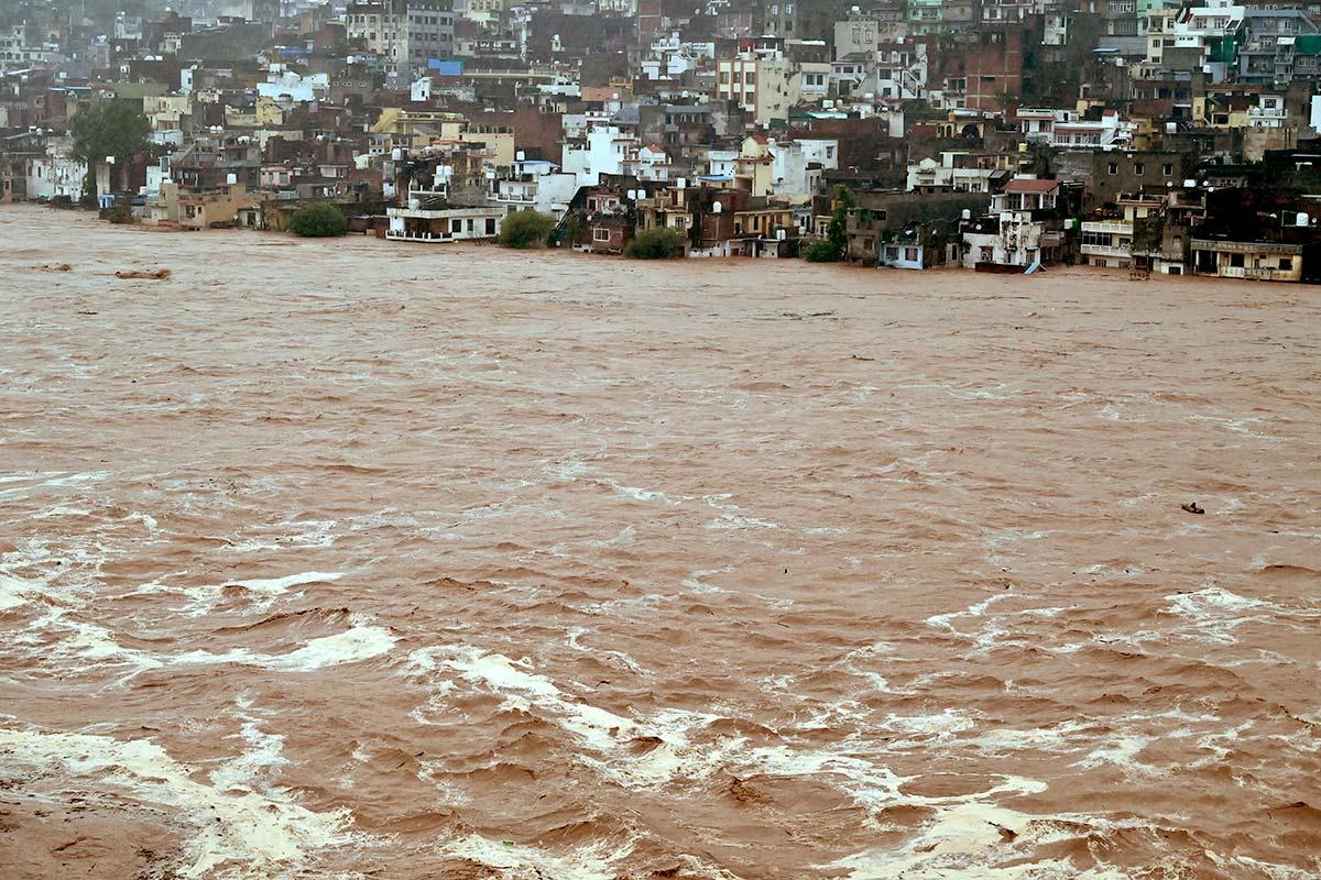 Water flows down overflowing Tawi River in Jammu Kashmir