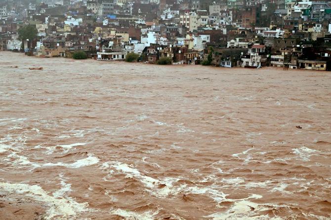Water flows down overflowing Tawi River in Jammu Kashmir Water flows down overflowing Tawi River in Jammu Kashmir
