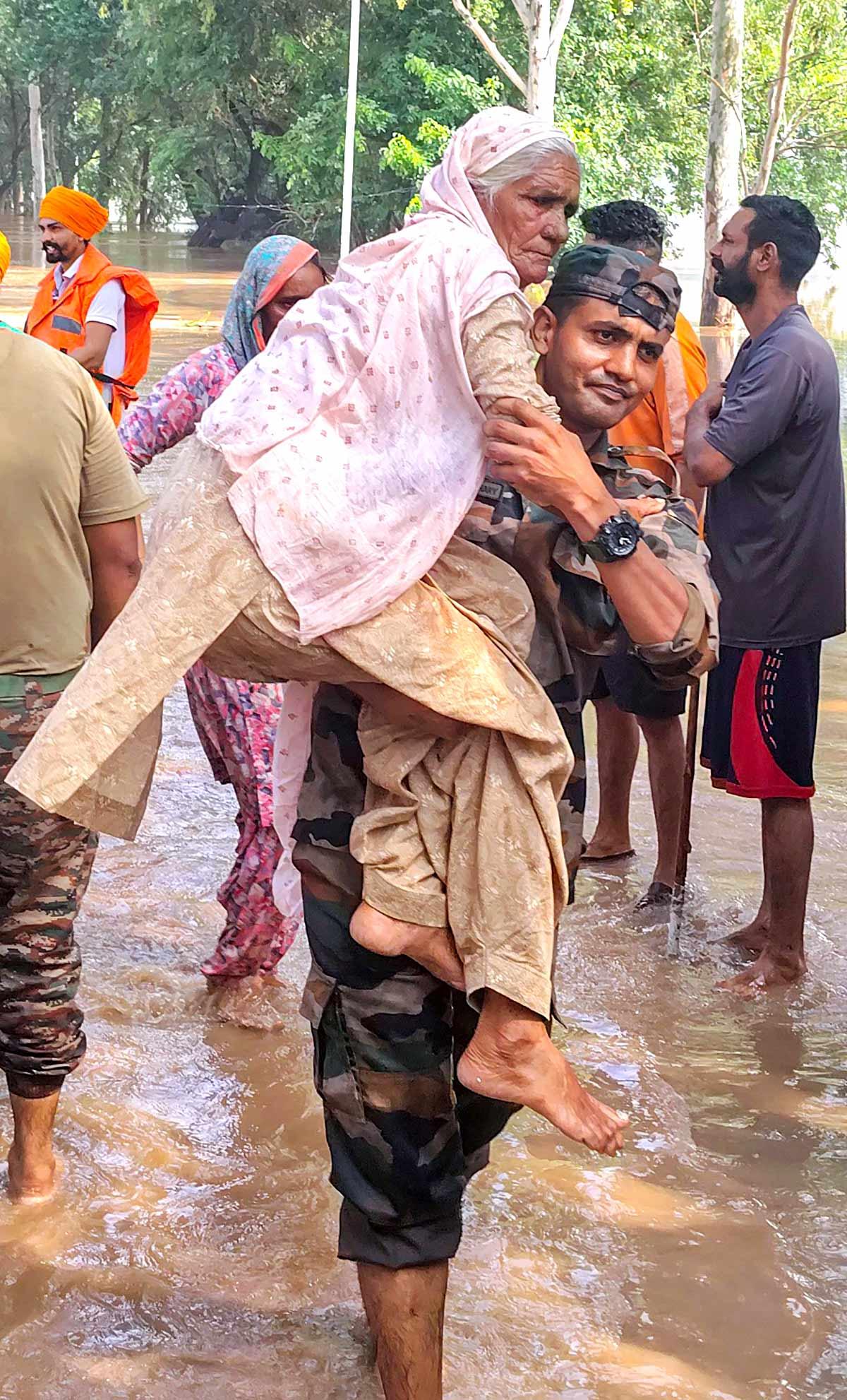 Army personnel rescue elderly during Ramdas flood operation Amritsar Army personnel rescue elderly during Ramdas flood operation Amritsar