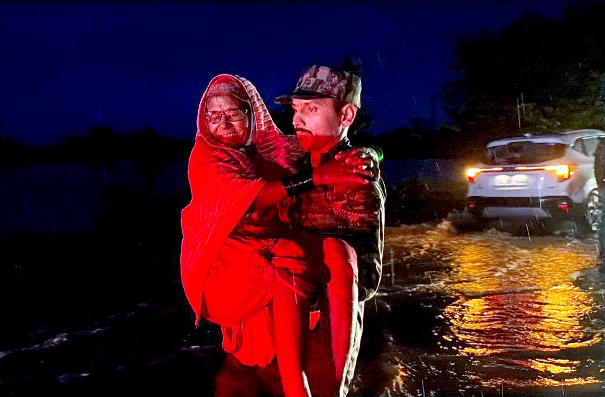 Security personnel rescue elderly woman in waterlogged Medak Telangana