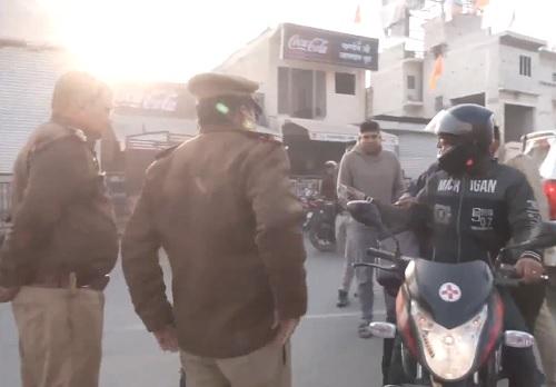 Cops checking motorists in Ayodhya on Saturday./ANI on X