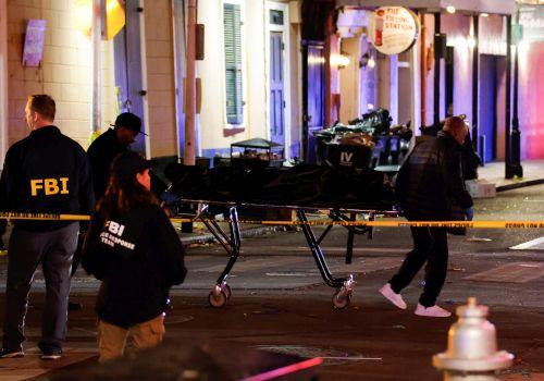 Police carry a dead body from the site. Pic: Eduardo Munoz/Reuters