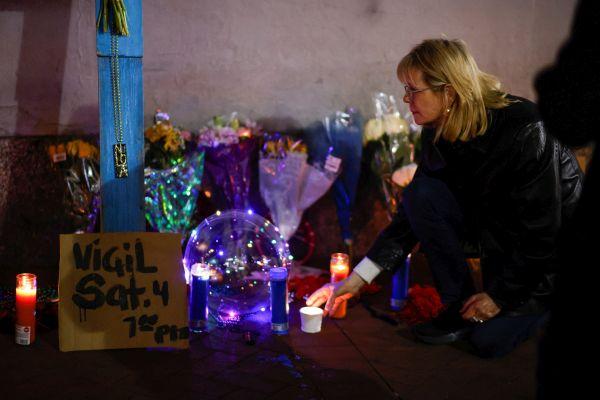 A woman pays homage at a memorial. Pic: Eduardo Munoz/Reuters