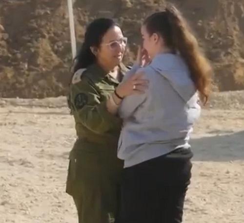 An IDF official receives Agam (right) after Hamas releases her/Image courtesy IDF on X