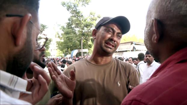 A man mourns a family member who died in the crash
