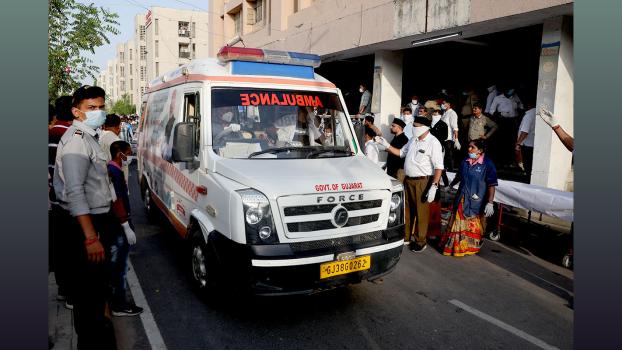 An ambulance carrying bodies arrives at the civil hospital in Ahmedabad