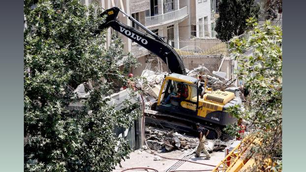 IMAGE: Rescuers work at the site of a damaged building, in the aftermath of Israeli strikes, in Tehran. Photograph: Majid Asgaripour/WANA via Reuters